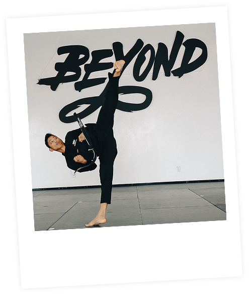 Master kicking in front of BEYOND mural